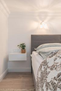 a bedroom with a bed and a plant on a night stand at CASA GIULIA BUDAPEST in Budapest