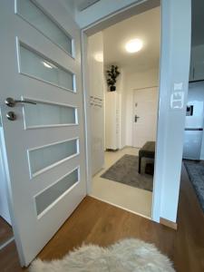a door leading into a hallway with a rug at Mistral Residence 408 in Balatonföldvár +2 photos