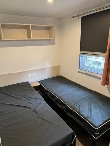 um quarto com duas camas e uma janela em MH TIKE - 6p - LES SABLES DU MIDI - VALRAS em Valras-Plage