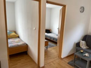 a room with a mirror and a bed and a couch at Domek wypoczynkowy Leszek in Żarnowska