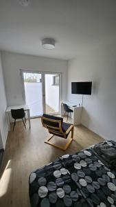 a bedroom with a bed and two chairs and a desk at Ferienwohnung Hesse Ilsede in Ilsede