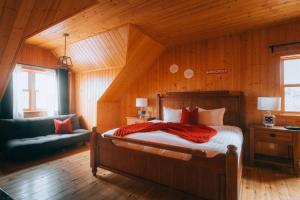 a bedroom with a bed and a couch in a room at Private Hot Tub Sauna Indoor pool ski Monopoly in Mille-Isles +56 photos