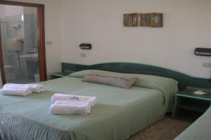 Postel nebo postele na pokoji v ubytování Hotel Concordia Palace
