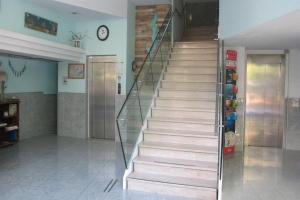 a staircase in a room with a stair case at Hotel Concordia Palace in Rimini