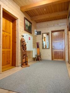 a room with a door and a statue in a room at Apartamenty u drwala in Zakopane