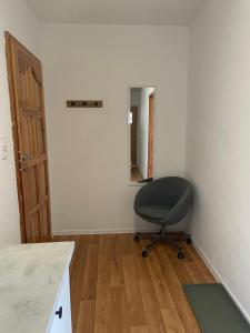 an empty room with a chair and a mirror at Apartamenty AGAT in Pieszyce