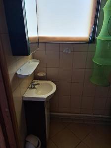 a small bathroom with a sink and a window at Domek Ostrowo in Ostrowo +11 photos