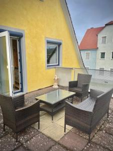 a patio with chairs and a table and a building at Casa Jungle Glanz Deluxe in Sigmaringen