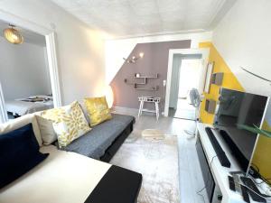 a living room with a couch and a table at Lumière Secrète Mulhouse Centre Parking Tram in Mulhouse
