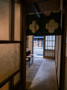 an entrance to a room with a door and some chairs at The　Nomad　Inn　Gujo in Gujo