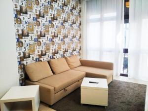 a living room with a couch and a wall of photos at LUNA AZUL, Centro Oviedo y con parking in Oviedo