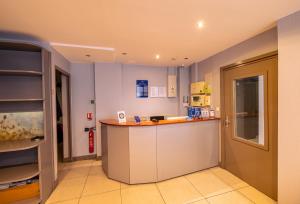 a kitchen with a counter in a room at Hotel Aix Europe in Paris