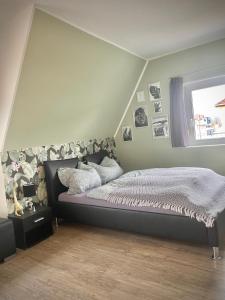 a bedroom with a bed and a wall with pictures at Casa Jungle Glanz Deluxe in Sigmaringen