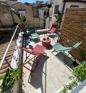 a group of chairs sitting on a patio at Aglaia apartment residence delle tre grazie in Syracuse