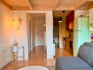 a kitchen and a living room with a refrigerator at Apartamento Les Orenetes in Espinelvas