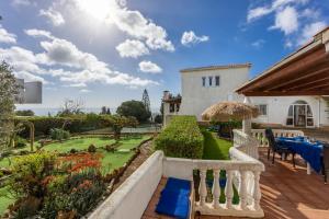 a view of the garden from the balcony of a house at Seaside Retreat Casa Romana in Luz
