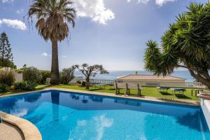 a swimming pool with a view of the ocean at Seaside Retreat Casa Romana in Luz