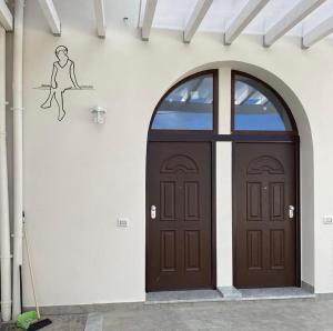 a door with a drawing of a woman on a wall at Donna Cuncetta Casa Vacanza Monte di Procida in Monte di Procida