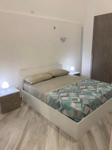 a bedroom with a bed and a wooden floor at Donna Cuncetta Casa Vacanza Monte di Procida in Monte di Procida +10 photos