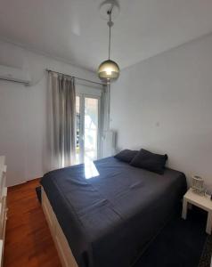 a bedroom with a large bed and a window at Apartment near Acropolis in Athens
