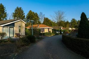 a house on a cobblestone road in front of a house at Ruim vakantiehuis met mooie tuin op de Veluwe in Putten