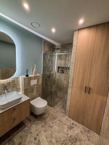 a bathroom with a toilet sink and a shower at Charming Apartment In Zeimena's Street in Kaunas