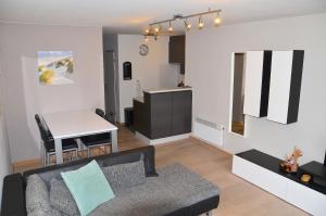 a living room with a couch and a table at SeeYou@Sea in Nieuwpoort