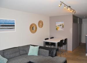 a living room with a couch and a table at SeeYou@Sea in Nieuwpoort