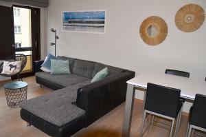 a living room with a couch and a table at SeeYou@Sea in Nieuwpoort +15 photos