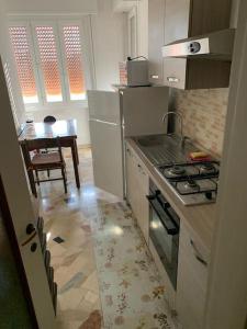 a small kitchen with a stove and a table at small panoramic flat in milan- one bedroom only in Milan
