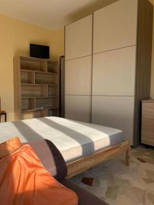 a bedroom with a bed and a large closet at small panoramic flat in milan- one bedroom only in Milan