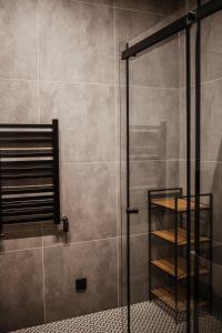 a shower with a glass door in a bathroom at Domek przy szlaku in Rabka-Zdroj