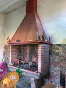 a brick fireplace in a room with a pumpkin at La maison d'Abelleira in Puenteareas