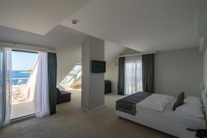 a bedroom with a bed and a view of the ocean at Boutique Hotel Life, Sea, Wellness & SPA in Rogoznica +45 photos