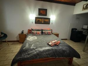a bedroom with a large bed with two pillows at Manzini chalets 8-9-10-37 in St Lucia