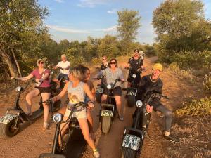 a group of people riding motorcycles on a dirt road at Lindiwe Safari Lodge in Hoedspruit