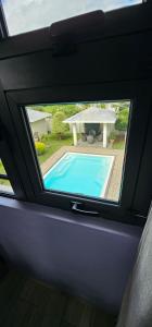 a view of a swimming pool through a window at Luxury Villa in Port Louis