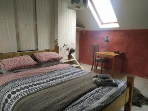 a bedroom with a large bed and a desk at Ballimackillichan Croft 