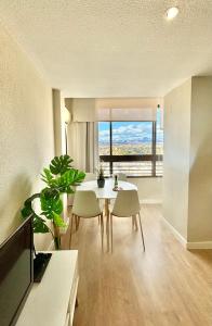 a living room with a table and chairs and a large window at Luceros Sky in Alicante