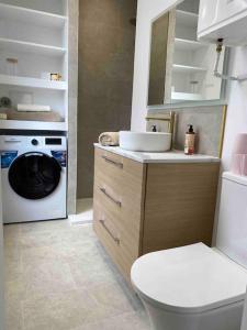 y baño con aseo y lavadora. en Appartement cozy - Centre ville - 10 min Paris, en Levallois-Perret