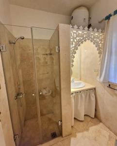 a bathroom with a shower and a sink at Cozy apartment in Downtown Gouna in Hurghada