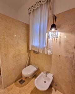 a bathroom with a toilet and a sink at Cozy apartment in Downtown Gouna in Hurghada