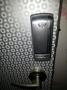 a toilet paper dispenser on a bathroom wall at Gyeongju Friend Guesthouse in Gyeongju