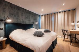 Postel nebo postele na pokoji v ubytování Hotel Les Mélèzes