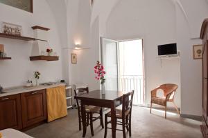 a kitchen and dining room with a table and chairs at La Corte Della Luce in Ugento