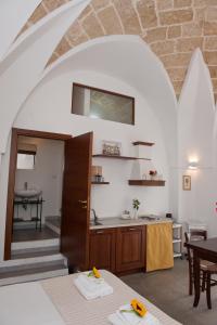 a kitchen and dining room with a table and a counter at La Corte Della Luce in Ugento