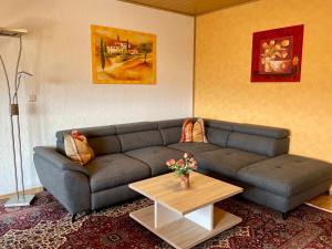a living room with a couch and a coffee table at Pension Höchemer in Bad Bocklet