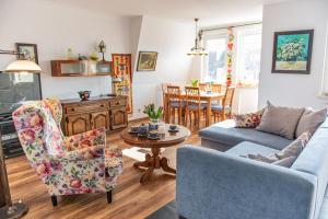 a living room with a couch and chairs and a table at Apartament Wiosenny in Szczecinek