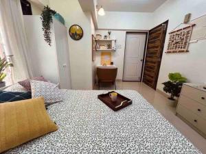 a bedroom with a bed with a tray on it at Dawn - A Spacious Modern Studio in Bandra at Almeida Park by Connekt Homes in Mumbai