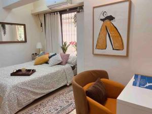 a living room with a bed and a chair at Dawn - A Spacious Modern Studio in Bandra at Almeida Park by Connekt Homes in Mumbai +16 photos